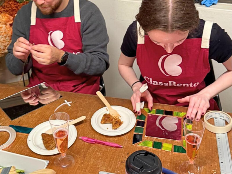 Two students at a stained glass workshop